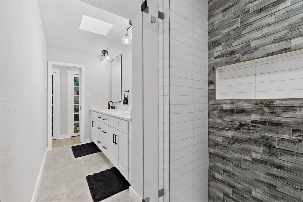 5015 Thunder Road Dallas, TX 75244 - Photo 17 of 31 a bathroom with a sink a toilet and shower