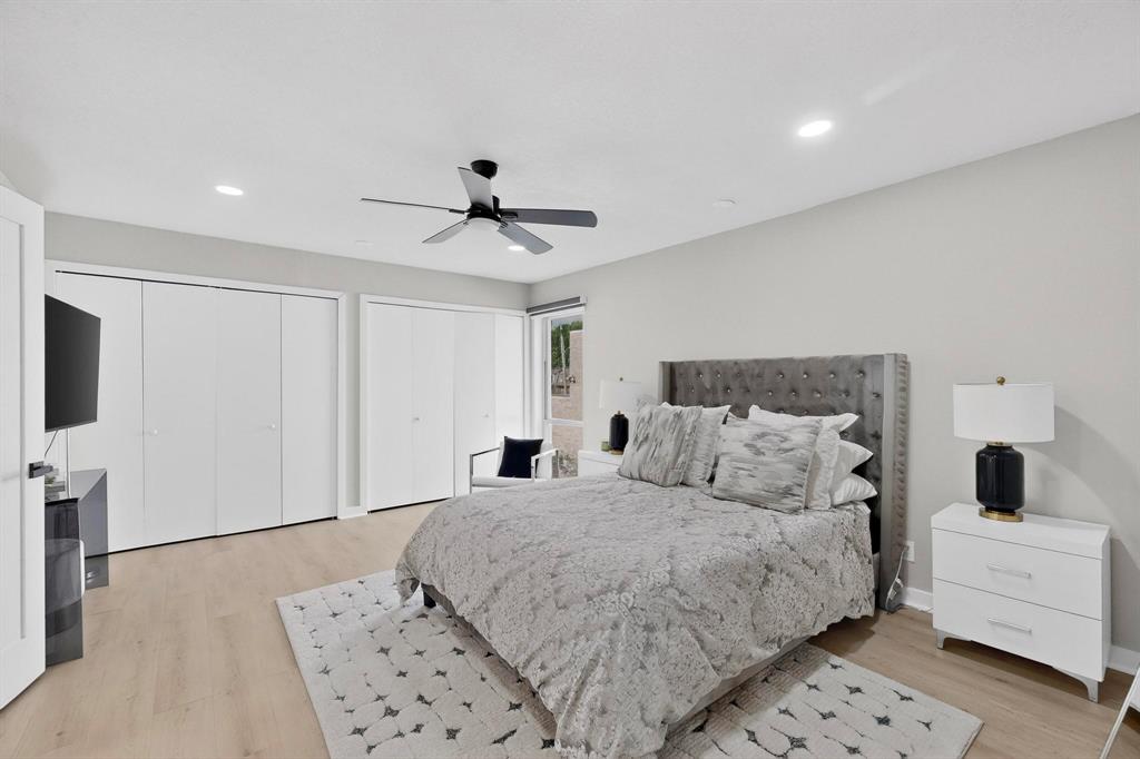5015 Thunder Road Dallas, TX 75244 - Photo 19 of 31 a bedroom with a large bed and a flat screen tv