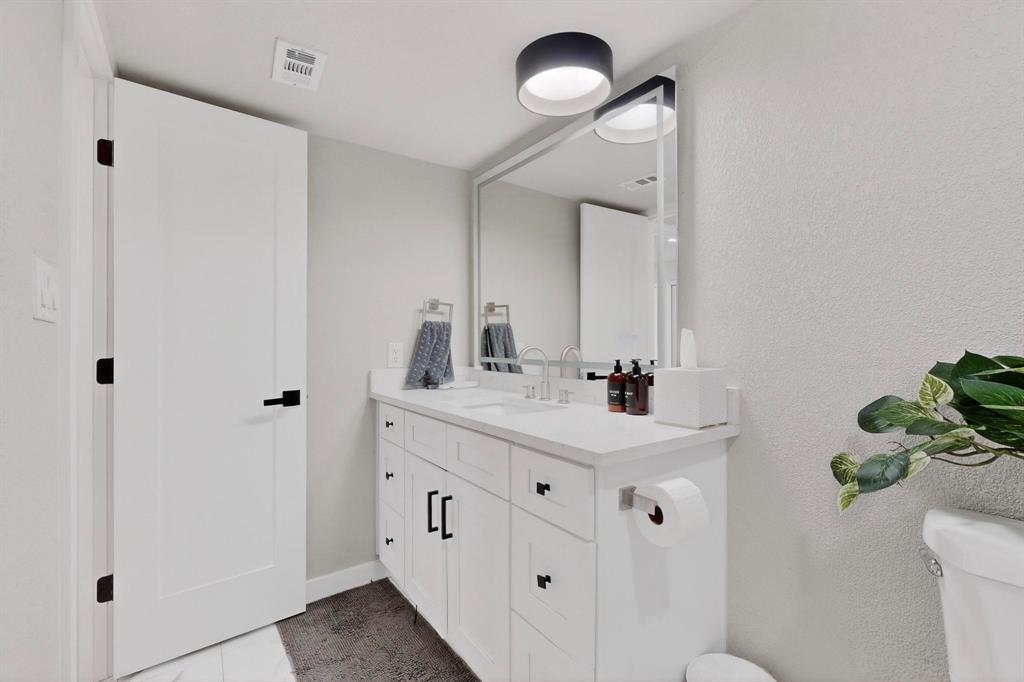 5015 Thunder Road Dallas, TX 75244 - Photo 9 of 31 a bathroom with a sink a toilet and a mirror