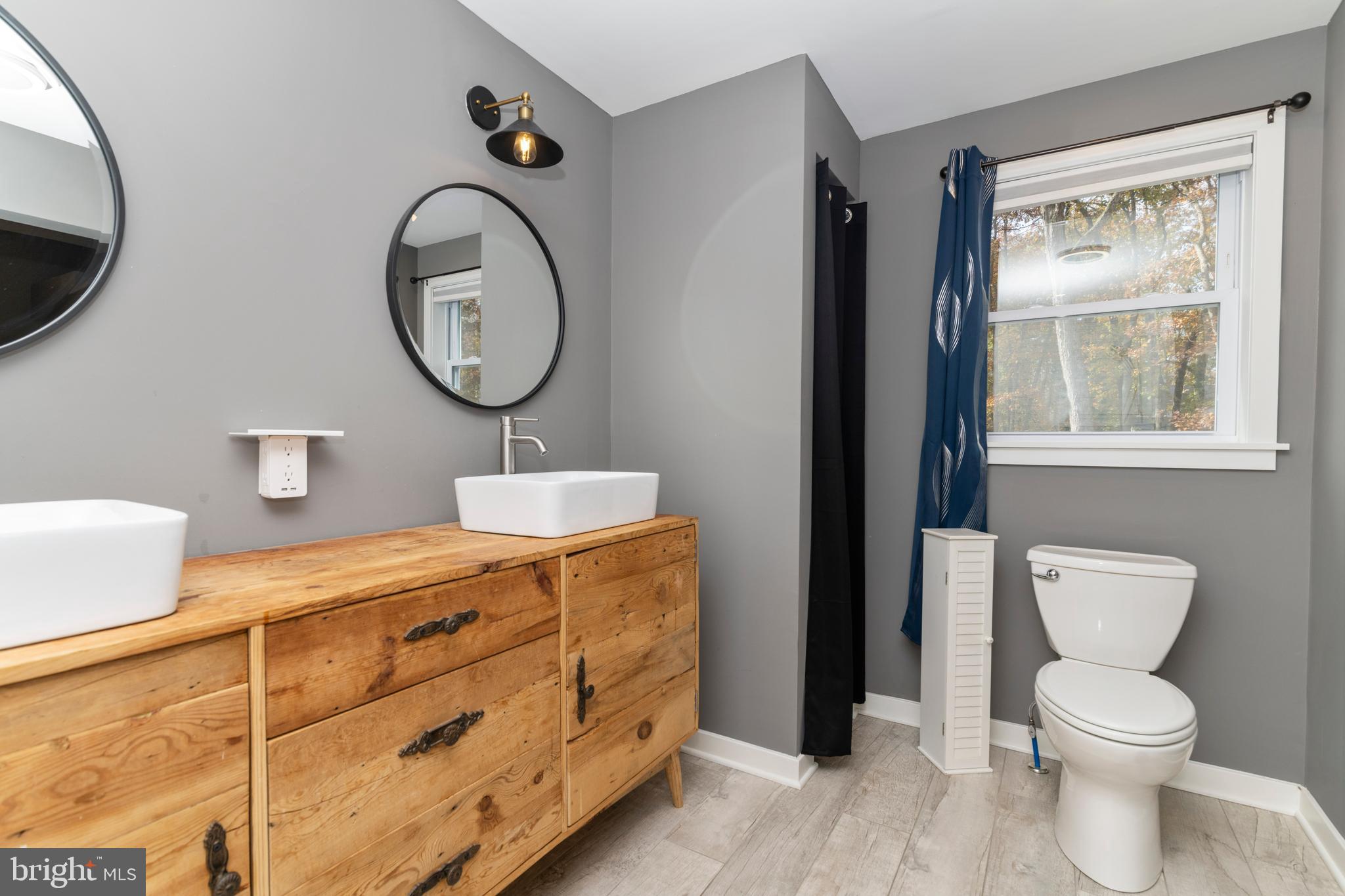 1414 Stokes Road Medford, NJ 08055 - Photo 12 of 55 a bathroom with a toilet a sink and a mirror