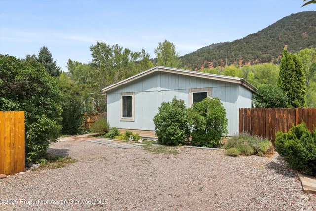 a view of a house with a yard and plants