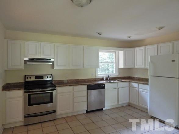 5013 Will-O-Dean Road Raleigh, NC 27616 - Photo 1 of 15 a kitchen with granite countertop a sink stove and cabinets
