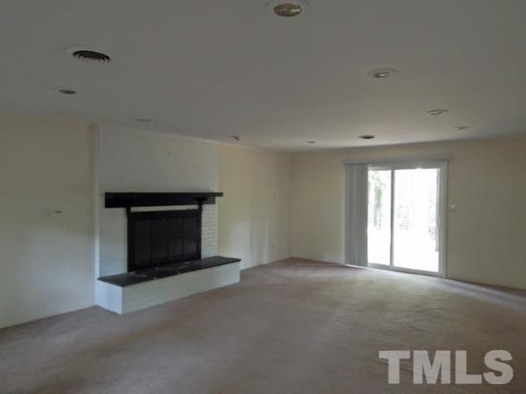 5013 Will-O-Dean Road Raleigh, NC 27616 - Photo 8 of 15 a living room with a fireplace and a window