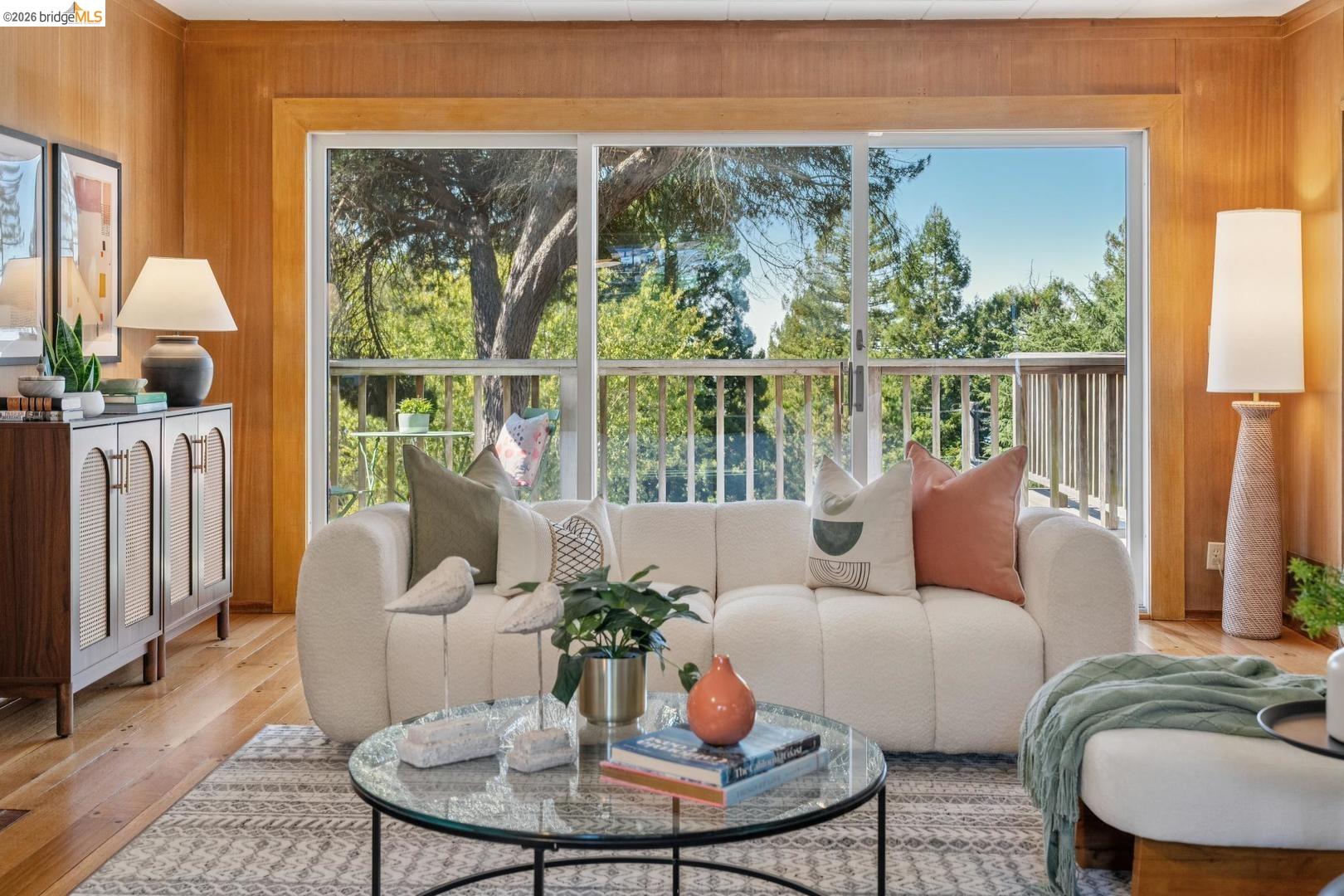 155 Avenida Drive Berkeley, CA 94708 - Photo 8 of 86 Wood paneling, expansive sliding glass doors, exterior balcony with railing, natural wood flooring, built-in storage cabinet