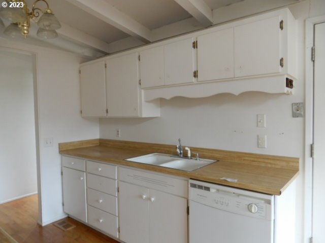 2455 Van Buren Street Eugene, OR 97405 - Photo 9 of 31 a kitchen with white cabinets and a sink