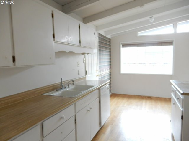 2455 Van Buren Street Eugene, OR 97405 - Photo 10 of 31 a kitchen with granite countertop white cabinets white appliances a sink and a window