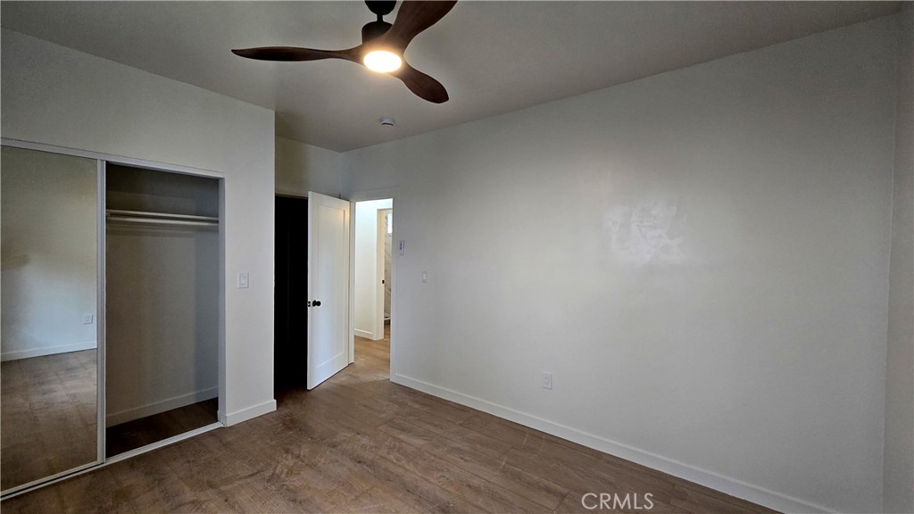 11171 Bullis Road Lynwood, CA 90262 - Photo 10 of 15 an empty room with closet and a chandelier fan
