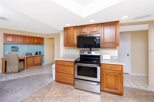 a kitchen with stainless steel appliances kitchen island granite countertop a sink dishwasher cabinets and granite countertops with wooden floor