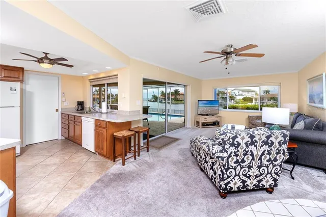a living room with furniture a couch and a ceiling fan