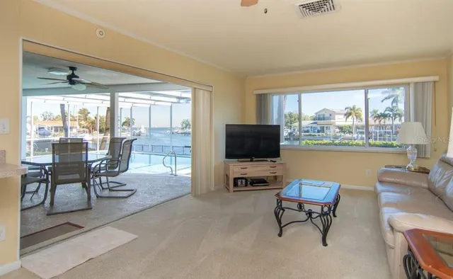 a living room with furniture a couch and a ceiling fan