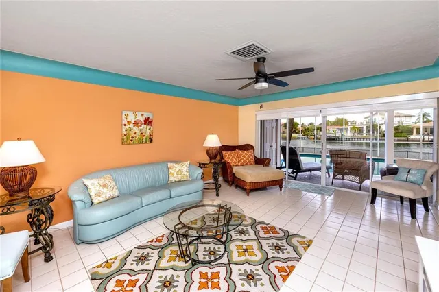 a living room with furniture and a floor to ceiling window