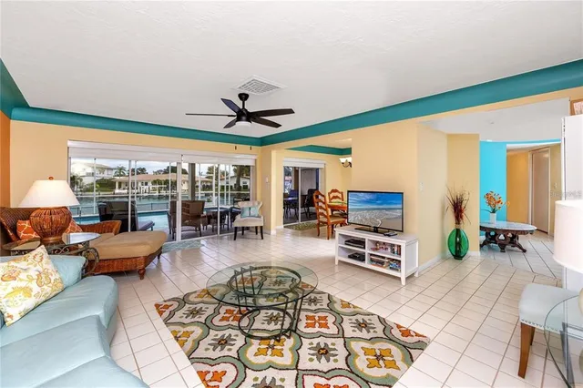 a living room with furniture and a large window with wooden floor