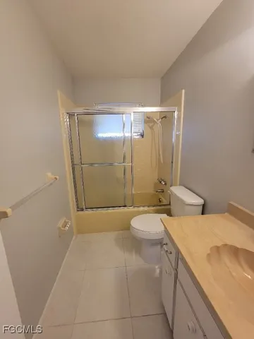 a bathroom with a granite countertop sink a toilet and shower