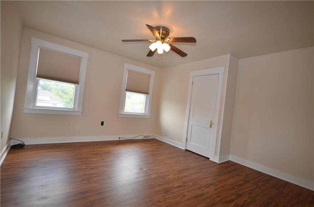 1020 6th Street Beaver, PA 15009 - Photo 16 of 33 a view of an empty room with wooden floor and a window