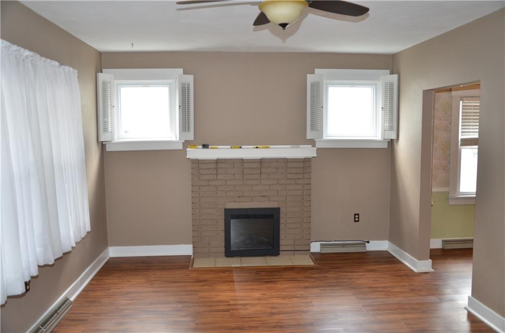 1020 6th Street Beaver, PA 15009 - Photo 4 of 33 an empty room with windows and fireplace