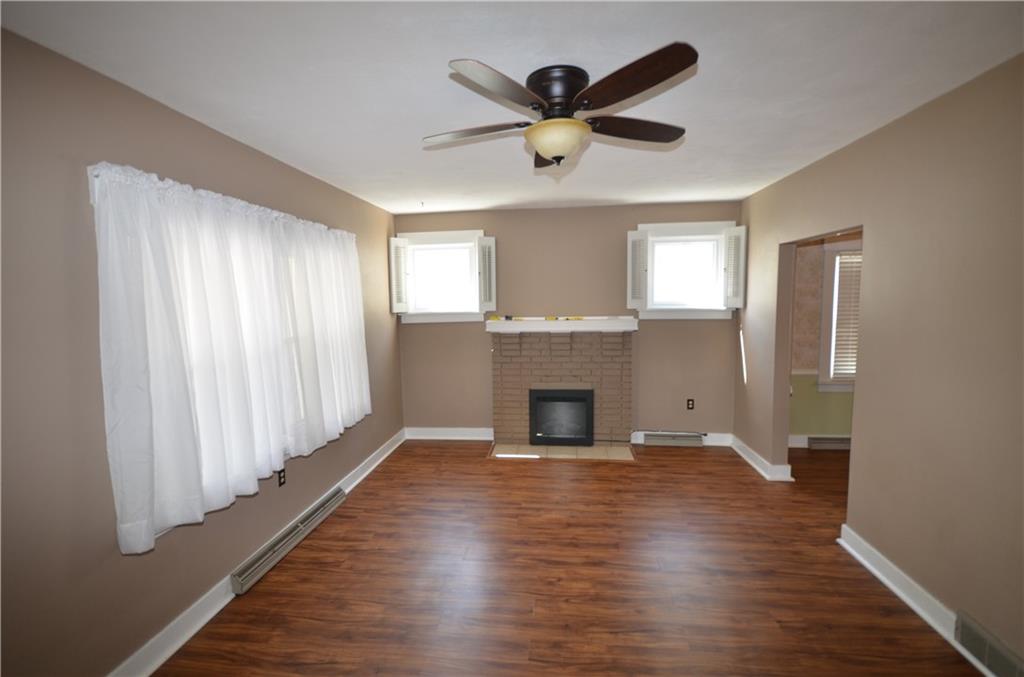 1020 6th Street Beaver, PA 15009 - Photo 5 of 33 an empty room with wooden floor a ceiling fan and windows