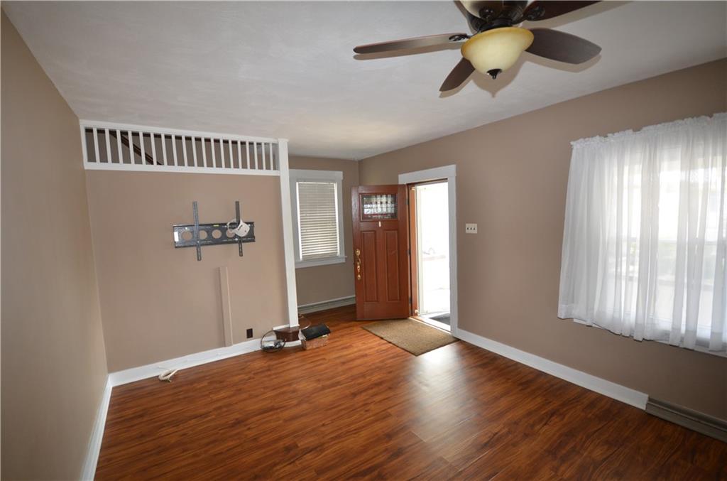 1020 6th Street Beaver, PA 15009 - Photo 6 of 33 an empty room with wooden floor and windows