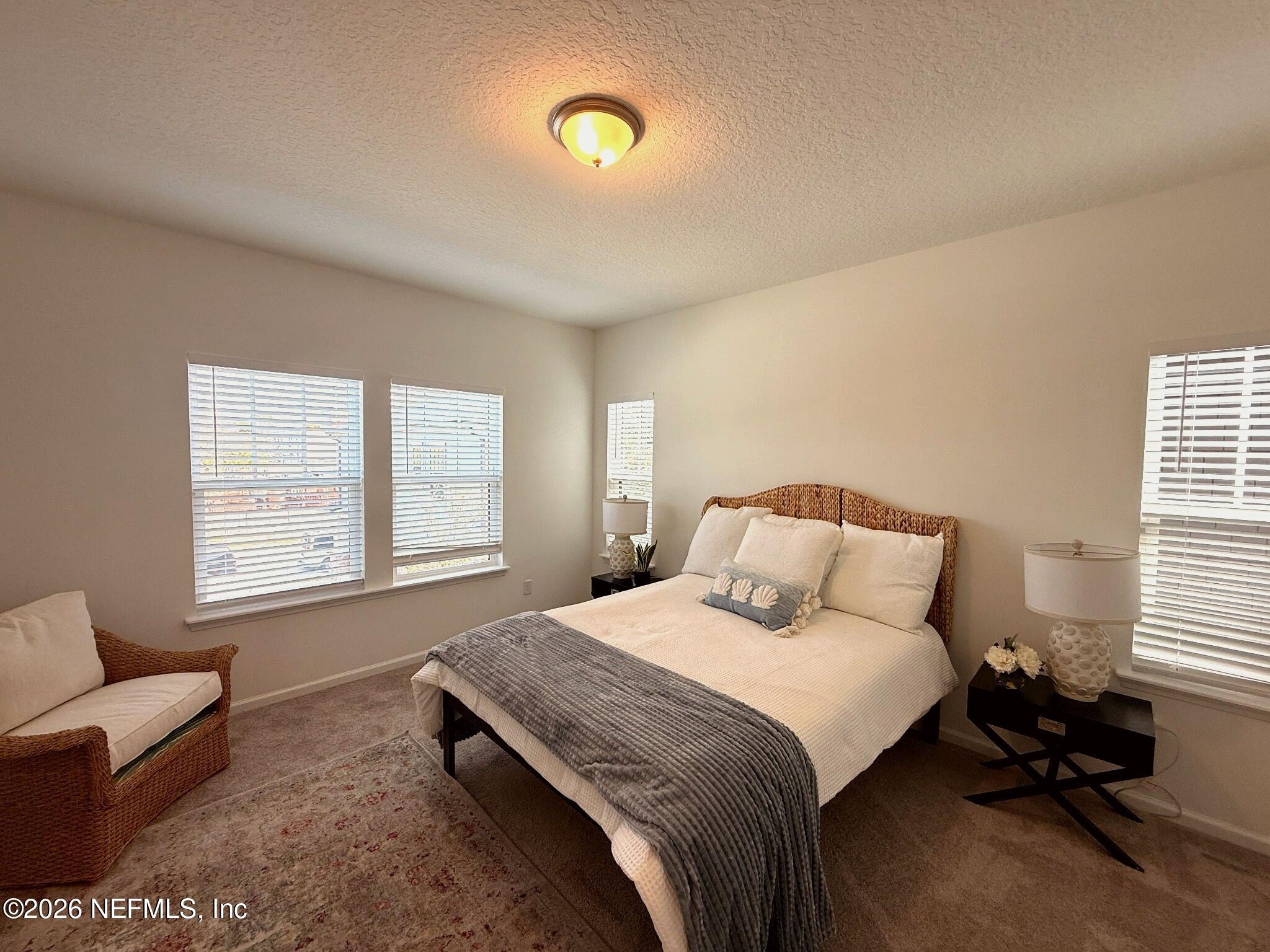 2913 Fleur Lane Jacksonville, FL 32205 - Photo 12 of 22 a bedroom with a bed and a couch