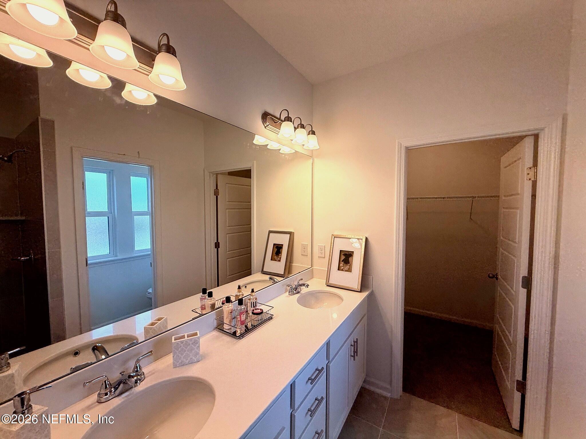 2913 Fleur Lane Jacksonville, FL 32205 - Photo 14 of 22 a bathroom with a sink vanity and a mirror