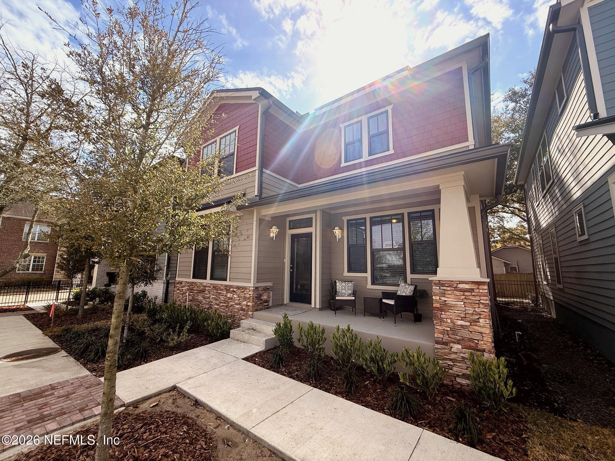 2913 Fleur Lane Jacksonville, FL 32205 - Photo 2 of 22 a view of a brick house with many windows next to a road