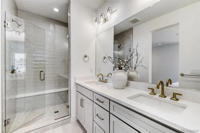 a bathroom with a shower sink and mirror