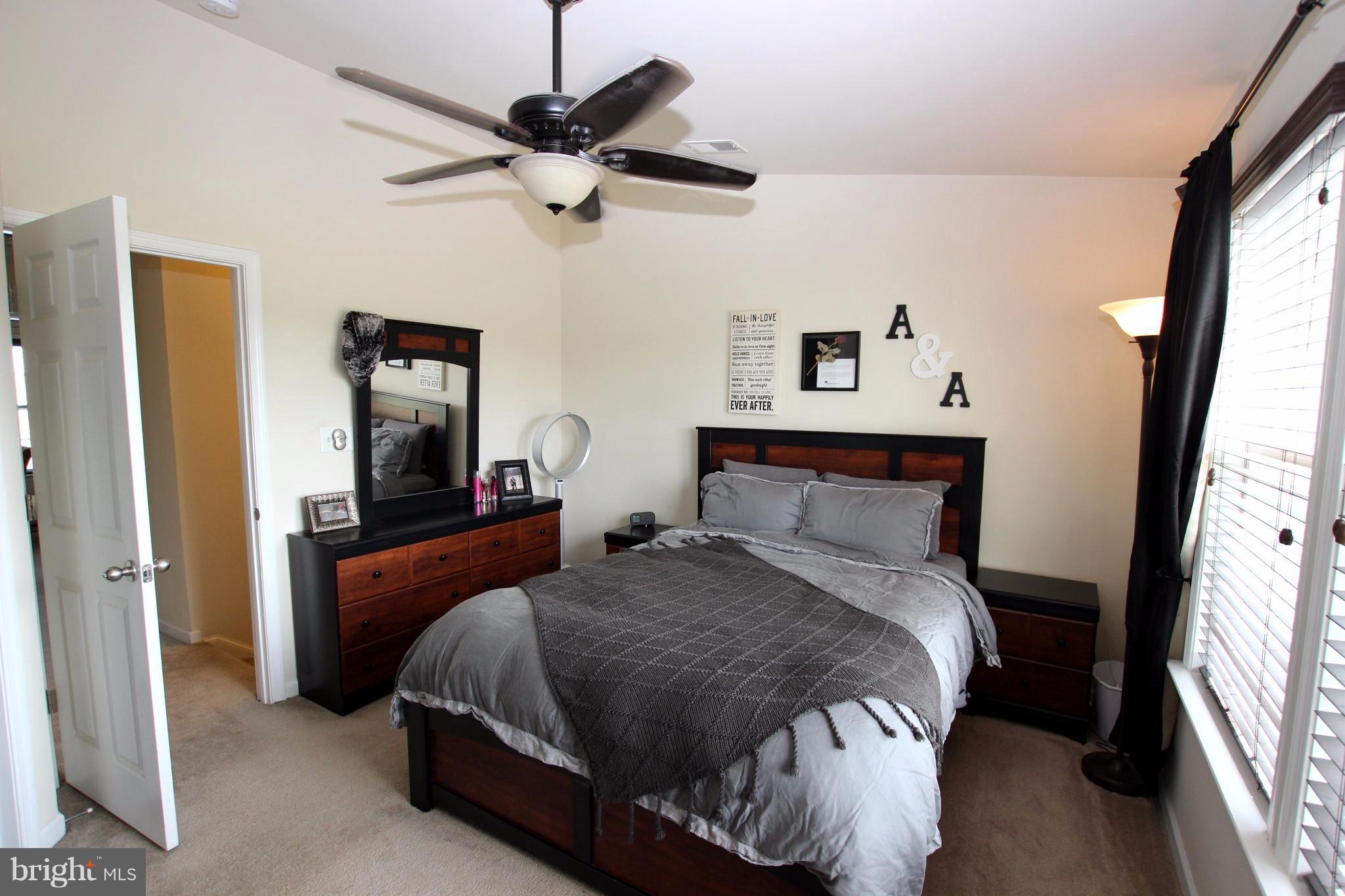 1129 Stallion Street Ranson, WV 25438 - Photo 13 of 19 a bedroom with a bed and a chandelier