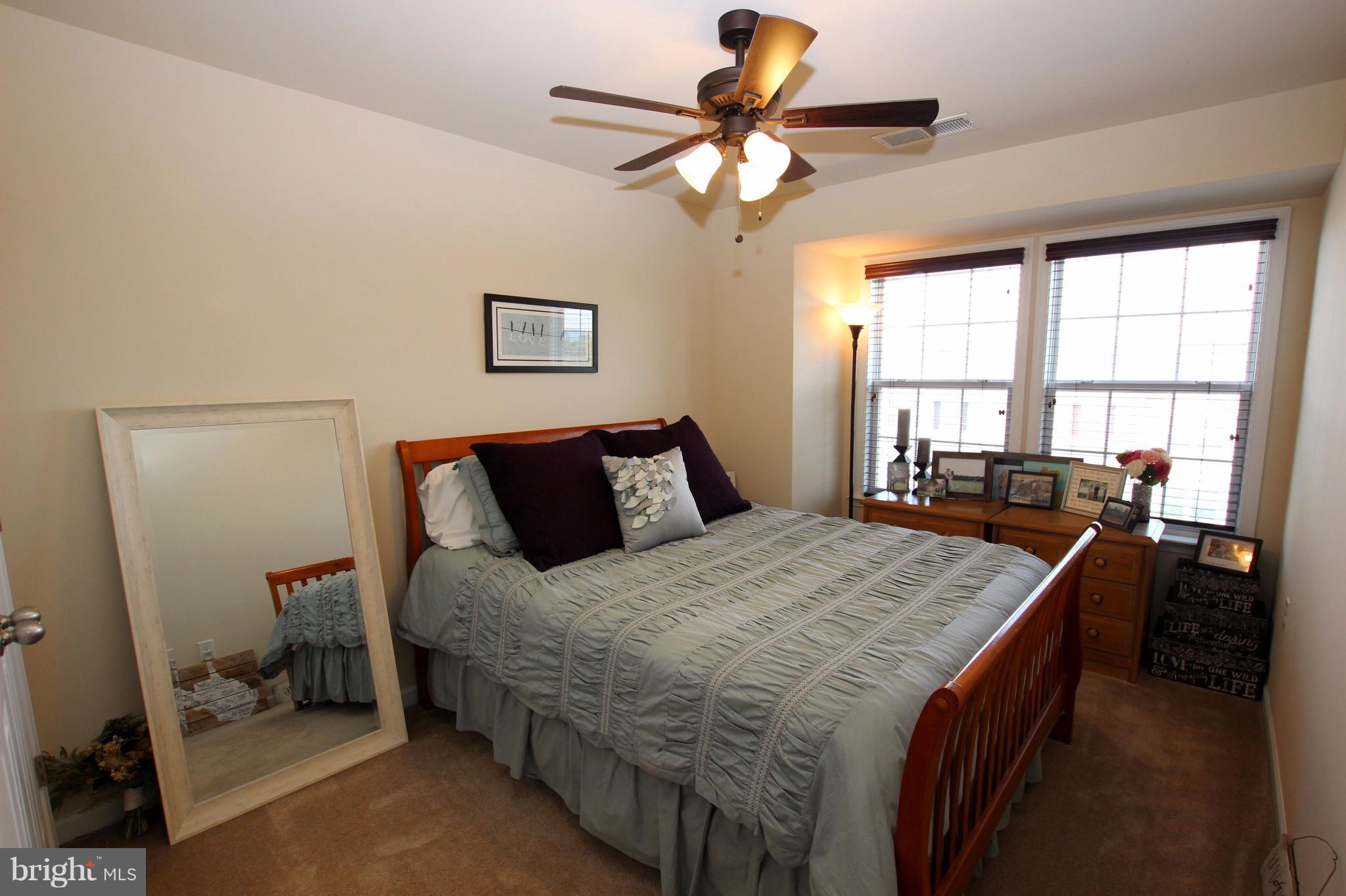 1129 Stallion Street Ranson, WV 25438 - Photo 16 of 19 a bedroom with a bed and a chandelier