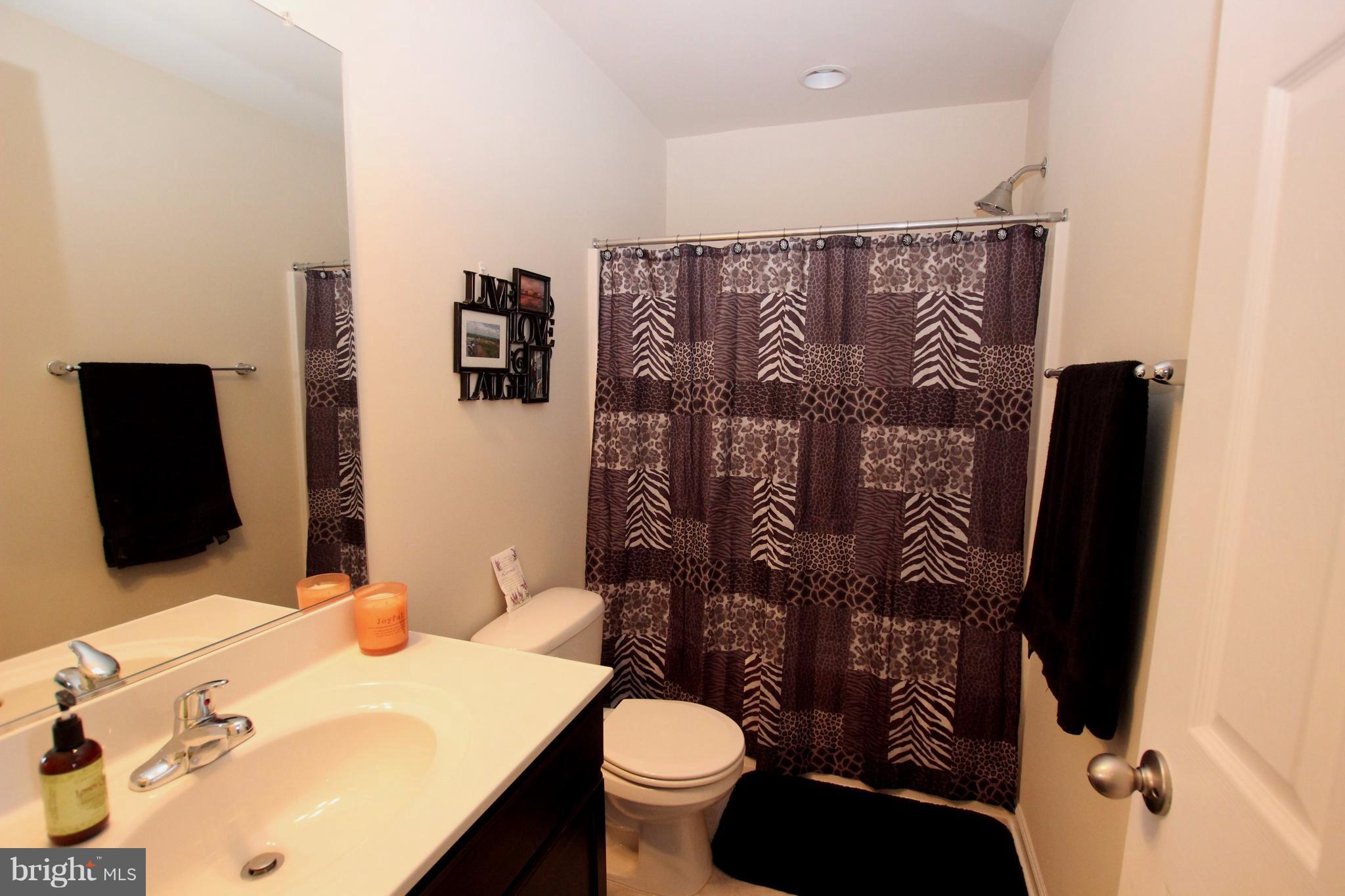 1129 Stallion Street Ranson, WV 25438 - Photo 17 of 19 a bathroom with a toilet sink and mirror