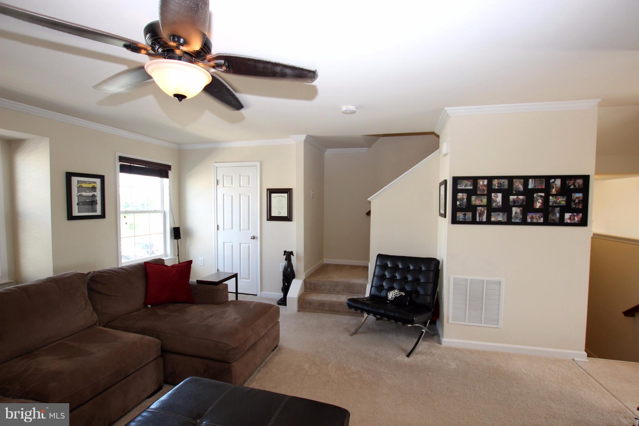 1129 Stallion Street Ranson, WV 25438 - Photo 6 of 19 a living room with furniture and a ceiling fan