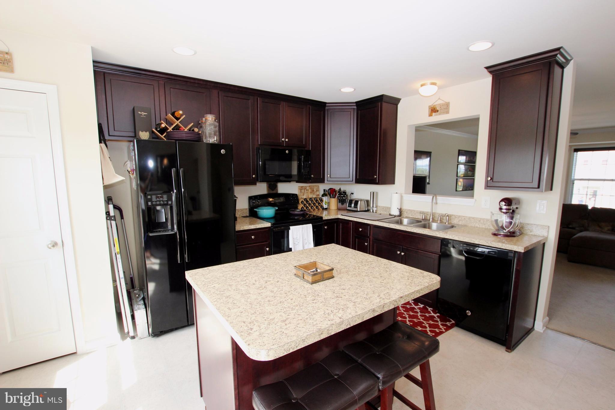 1129 Stallion Street Ranson, WV 25438 - Photo 8 of 19 a kitchen with a dining table and chairs