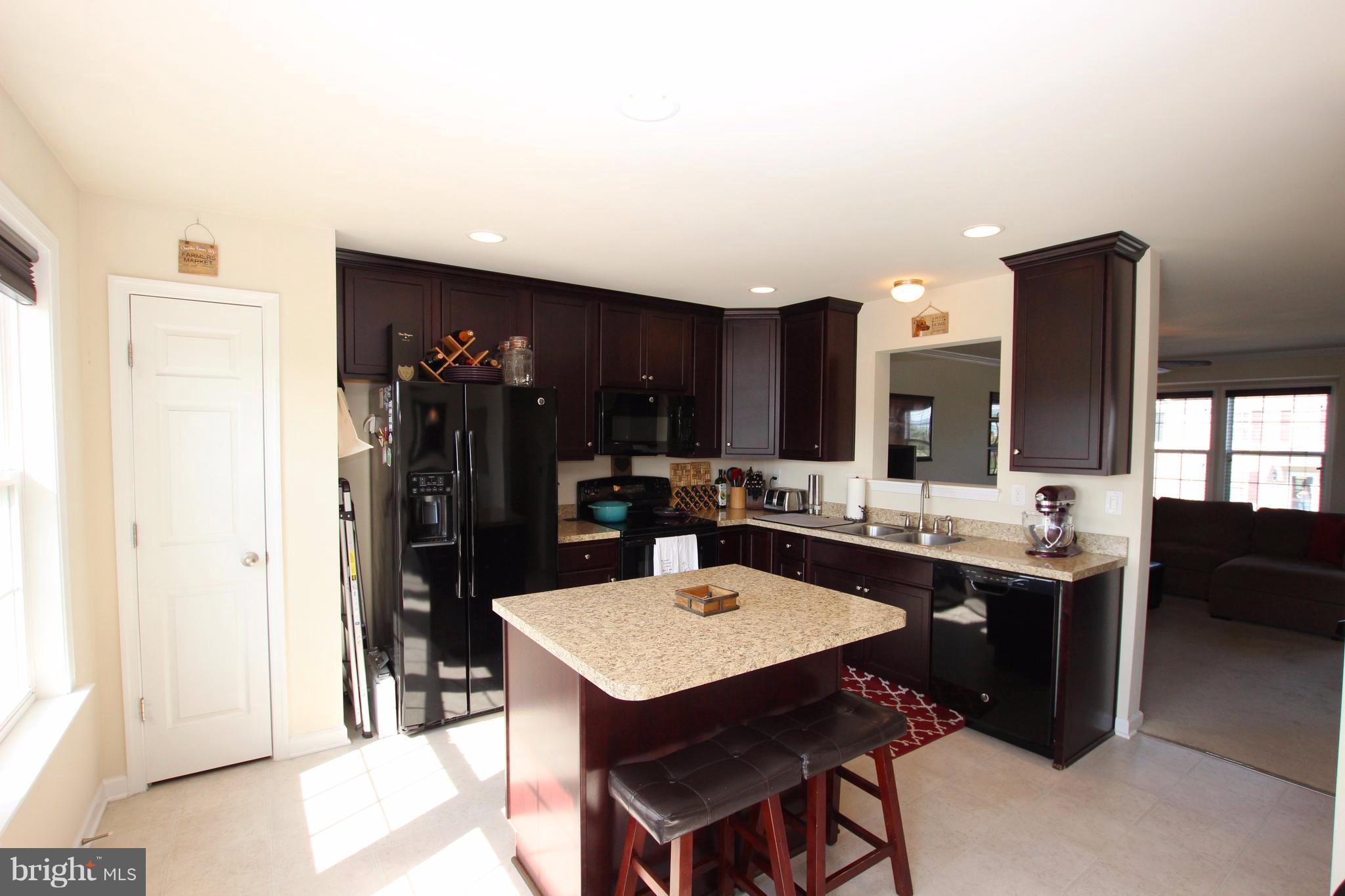 1129 Stallion Street Ranson, WV 25438 - Photo 9 of 19 a kitchen with a table and chairs in it
