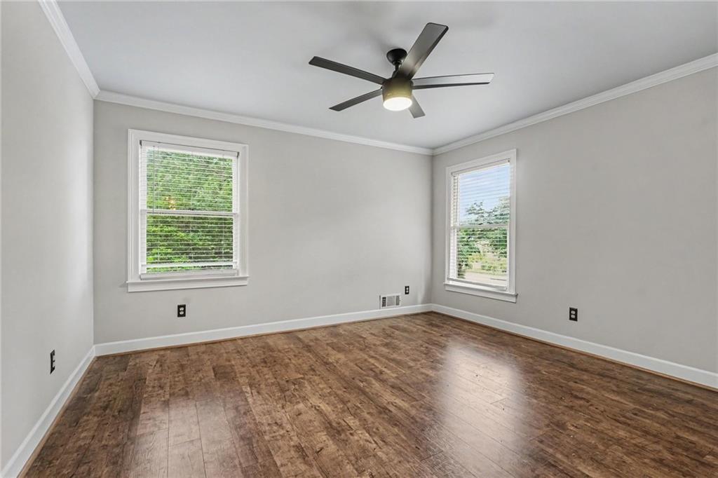 3597 Smithtown Road Suwanee, GA 30024 - Photo 13 of 24 a view of a big room with wooden floor and windows