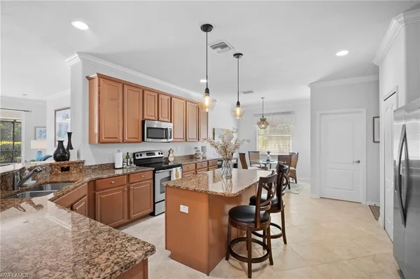 a large kitchen with stainless steel appliances lots of counter top space