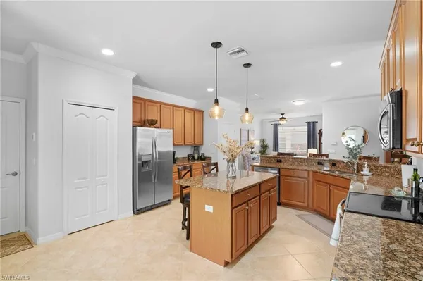 a kitchen with center island and stainless steel appliances