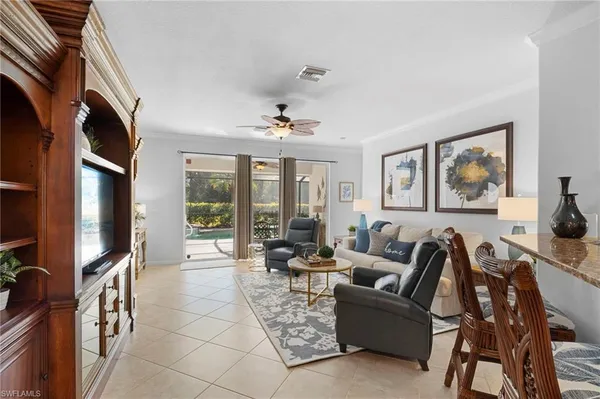 a living room with furniture kitchen view and a dining table
