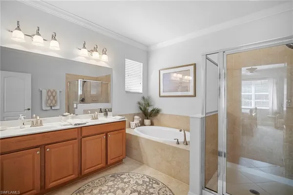 a bathroom with a tub sink and mirror