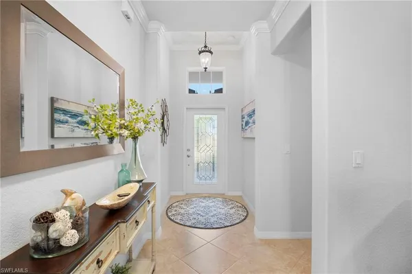a living room with furniture a chandelier and a rug