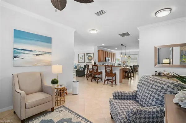 a large kitchen with a table and chairs