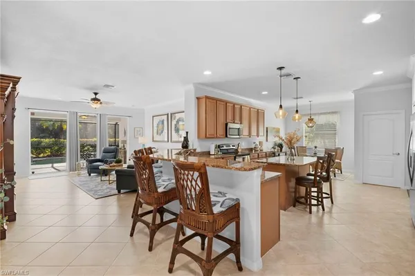 a kitchen with a sink a counter top space appliances and cabinets