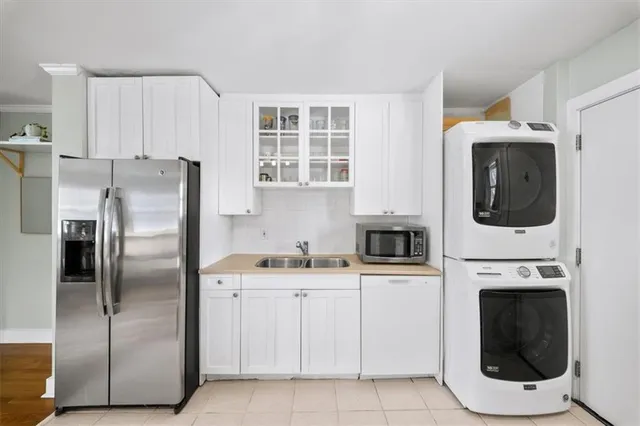 a kitchen with stainless steel appliances a refrigerator a stove a microwave and sink