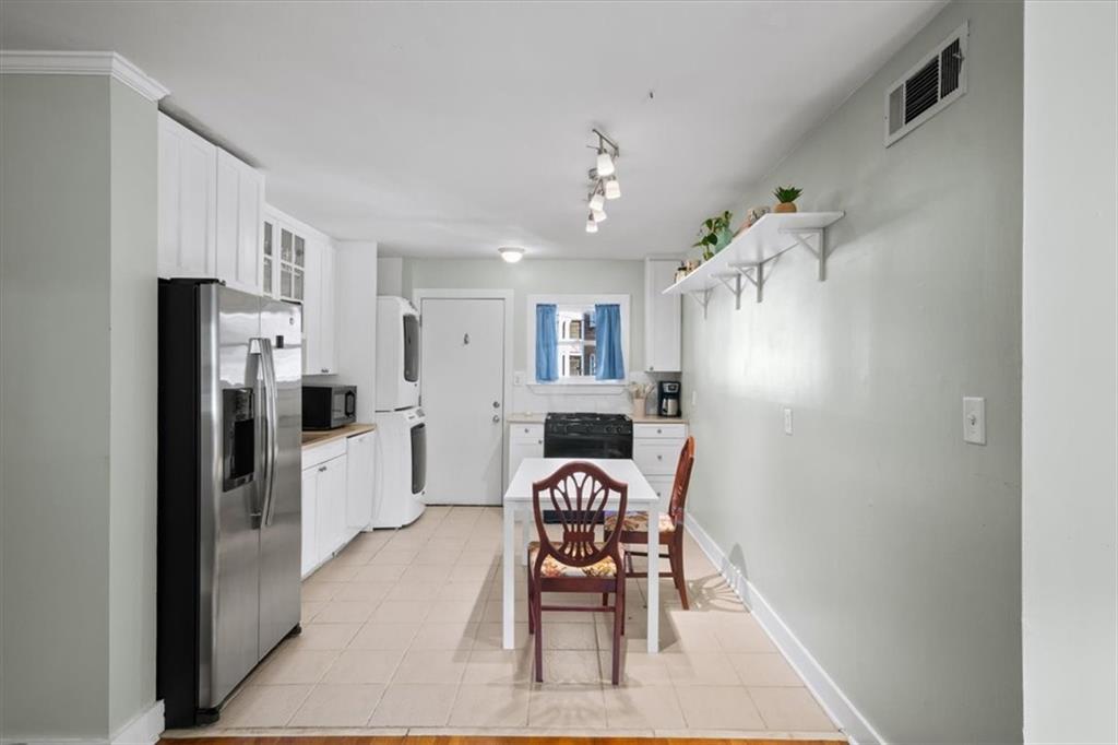 866 Briarcliff Road Northeast, Unit D2 Atlanta, GA 30306 - Photo 14 of 42 a kitchen with a refrigerator a dining table and chairs