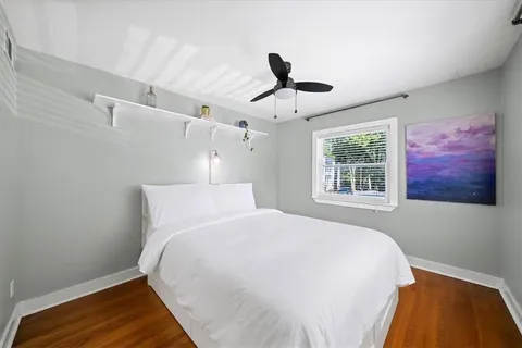 a bedroom with a bed and wooden floor