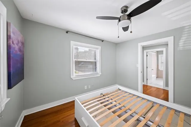 a view of a room with a ceiling fan and a window