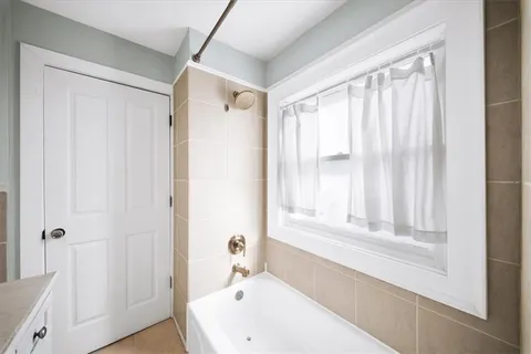 a bathroom with a bathtub and a shower