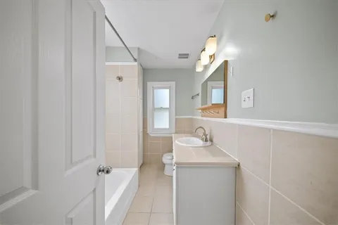a bathroom with a sink vanity and mirror