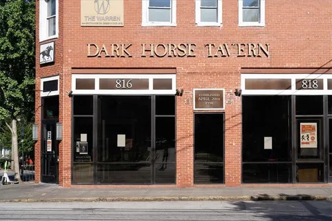 a group of people sitting outside of a building