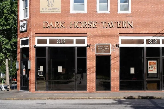 a group of people sitting outside of a building