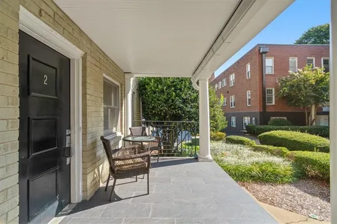 a patio with yard glass top table and chairs