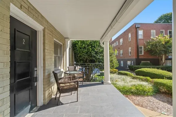a patio with yard glass top table and chairs