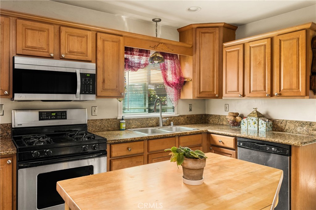 950 North Laurel Drive Orange, CA 92867 - Photo 13 of 34 a kitchen with a stove a sink and a microwave